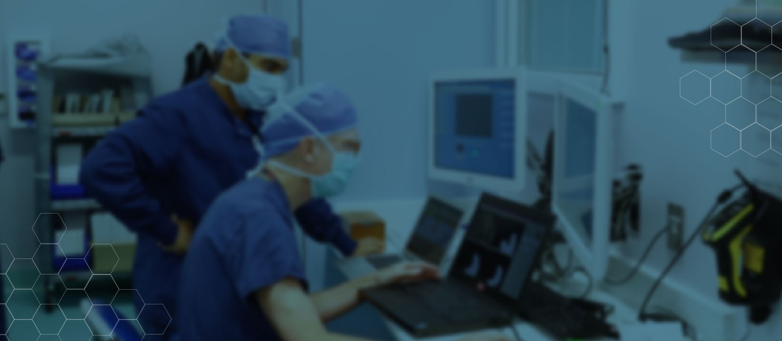 Surgeons examine test results on laptop